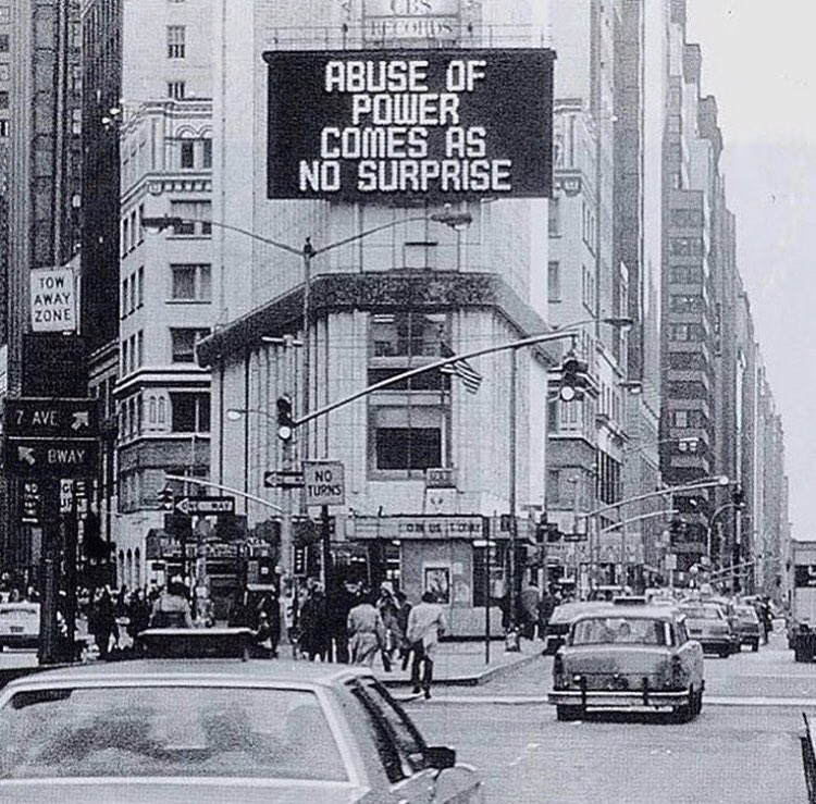 Jenny Holzer art on sign attached to city building